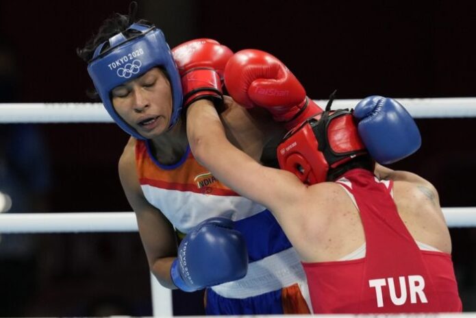 India’s sole boxer to be assured a medal at the Tokyo Olympics, Lovlina Borgohain put up a tough fight in her semi-final bout against reigning world champion and also the world number one Busenaz Surmeneli of Turkey, but eventually was beaten 5-0 Lovlina now finishes with a bronze in the women’s welterweight category. She is the third Indian boxer to win a medal at the Olympics after Vijender Singh and MC Mary Kom. Her medal also helps India better their 2016 Rio Olympic Games tally with PV Sindhu winning a bronze and Mirabai Chanu clinching a silver in Tokyo. Lovlina Borgohain was outplayed by the Turkish opponent and it was a unanimous decision in favour of the reigning world number one and world champion. The Indian 23-year-old started off on a positive note with aggressive punches but Surmeneli was in the driver's seat after the first minute of the contest. The Turkish boxer landed some big punches and was awarded the round unanimously by all 5 judges. She’s was given 10s by all while Lovlina was awarded 9s. In the second round, Lovlina was quick on the attack but Busenaz continued to be proactive in the ring. Both pugilists landed continuous punches but the Turkish boxer won the second round. Lovlina had five 9s from the judges, but got a deduction of one point for punching after the referee had closed the second round. The final round saw Lovlina trying to bridge the gap with body punches. But Busenaz started to avoid her punches and landed a left hook followed by an uppercut. Lovlina punched non-stop till the end, but it was too late to make a turnaround against Busenaz's persistent attack Surmeneli, the gold medal favourite, finished with perfect 10s in all rounds and will progress onto the final while Lovlina will also be on the podium, with a bronze.