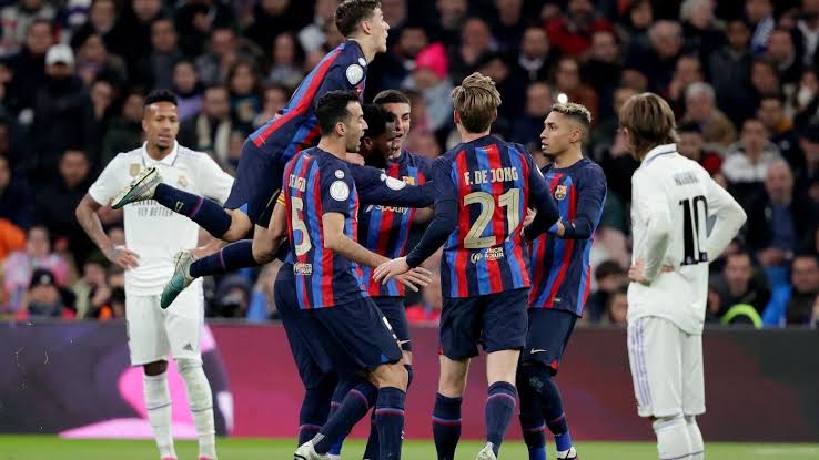 Barca﻿ players celebrating after Real Madrid concede﻿ an own goal at the Bernabeu. 