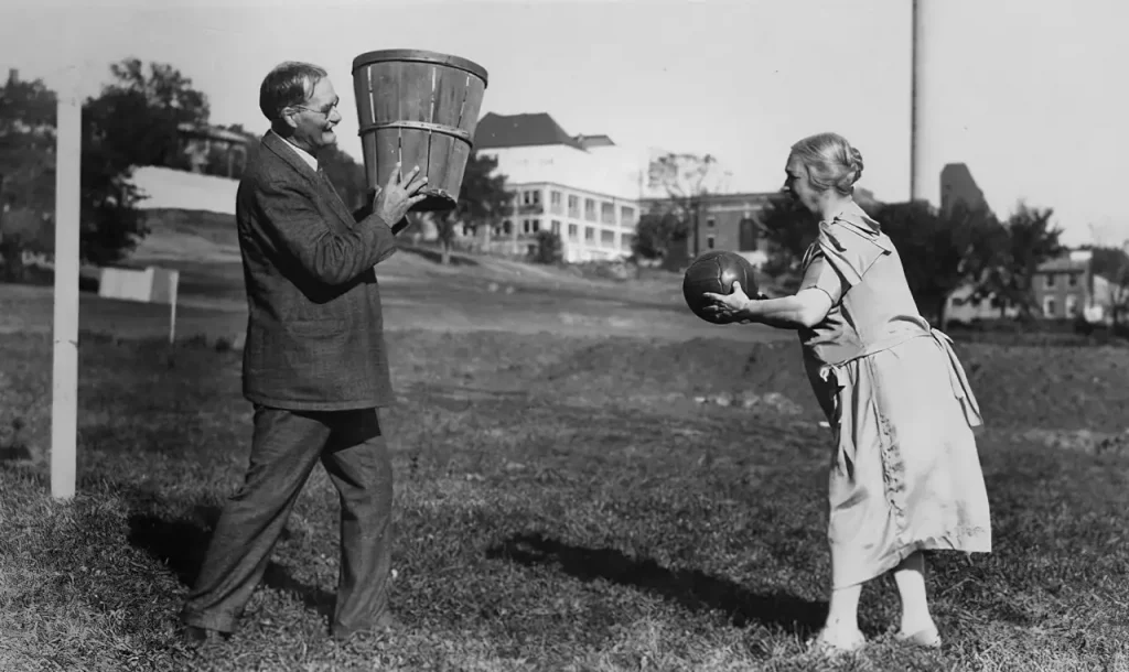 An Old Photo depicting male and female playing basketball